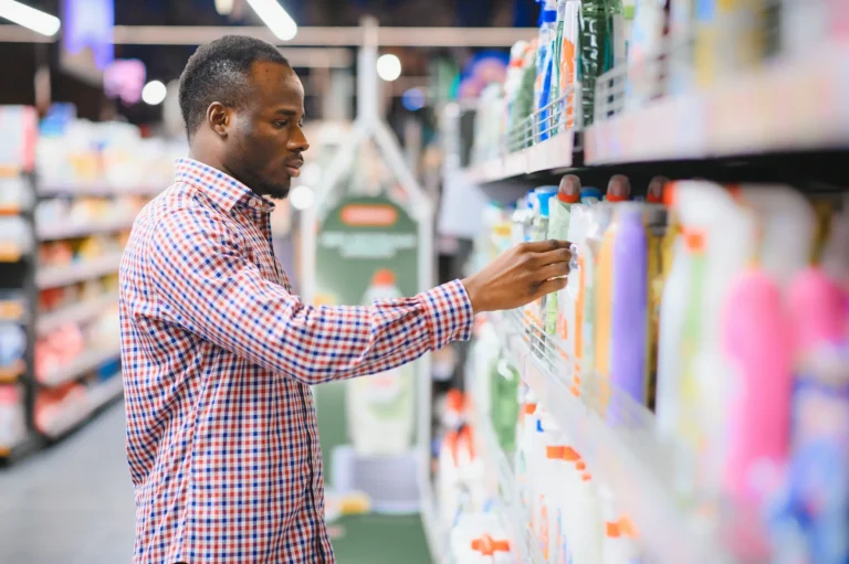 Ethnic black man selecting cleaning products in a Melbourne supermarket